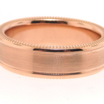 Rose gold ring with a beveled edge on a white background