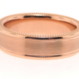 Rose gold ring with a beveled edge on a white background